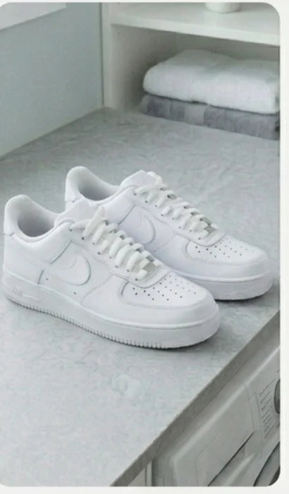 Clean white trainers drying on a worktop after the wash